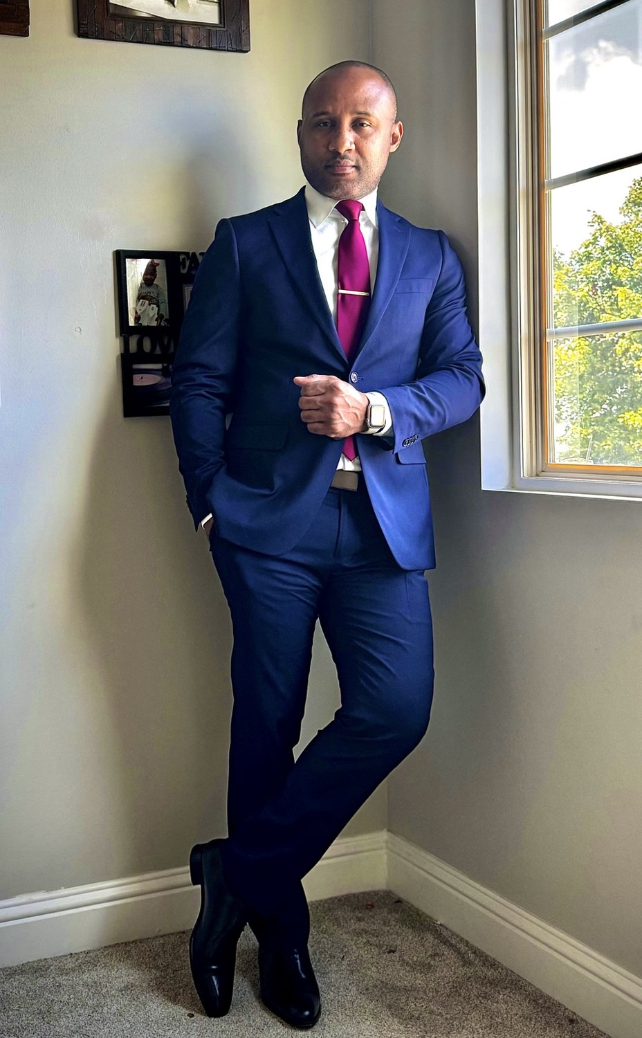Alex in a blue suit and burgundy tie